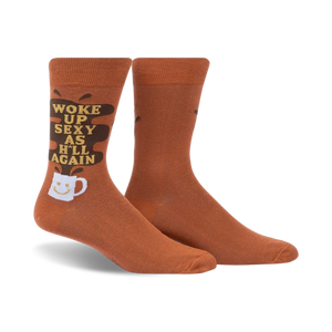 Pair of brown crew socks with a funny 'Woke Up Sexy As Hell Again' slogan and coffee cup graphic. Dark brown coffee spill design element.