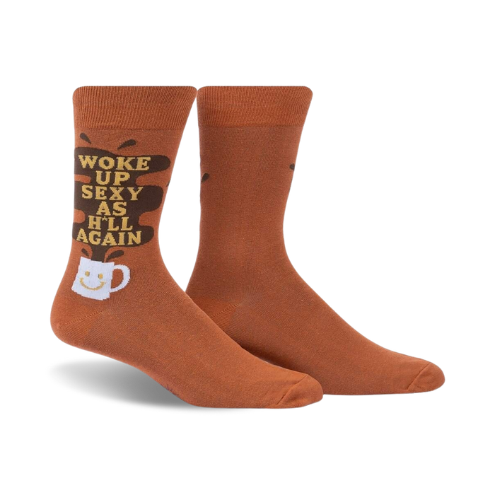Pair of brown crew socks with a funny 'Woke Up Sexy As Hell Again' slogan and coffee cup graphic. Dark brown coffee spill design element.