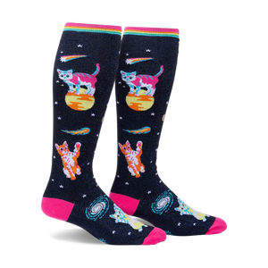 Pair of knee-high socks on a white background. Black background with pink, orange, and teal space cats, stars, and comets. Rainbow top cuff.