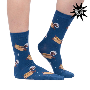 Lifestyle shot of a person wearing the Weiner Dogs, In Space! Glow in the Dark socks. The socks are partially visible.