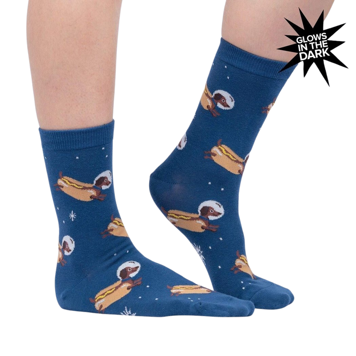 Lifestyle shot of a person wearing the Weiner Dogs, In Space! Glow in the Dark socks. The socks are partially visible.