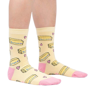 Lifestyle shot of a person's legs wearing the 'Butter Me Up' socks, showcasing the fit and overall style.