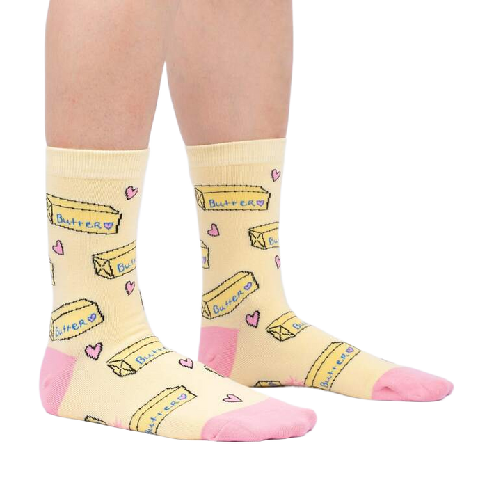 Lifestyle shot of a person's legs wearing the 'Butter Me Up' socks, showcasing the fit and overall style.