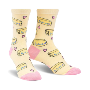 Pair of pastel yellow crew socks with a repeating pattern of butter pats and pink hearts. Pink accents on the heel and toe.
