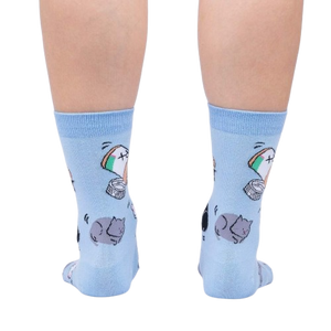 Close-up of the back of the light blue crew socks showcasing the cat and pill bottle design.