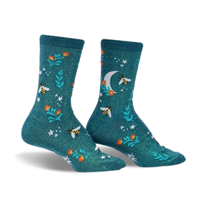 Pair of teal crew socks featuring a whimsical pattern of bees, flowers, a crescent moon, and stars.