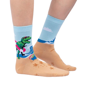 Lifestyle shot of Dinos Gone Wild socks on a person's feet, showcasing the beach-themed design.