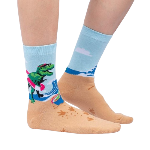 Lifestyle shot of Dinos Gone Wild socks on a person's feet, showcasing the beach-themed design.