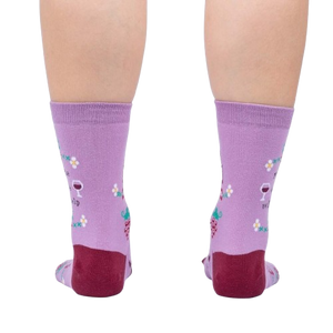 A pair of purple socks with a wine glass and grapes pattern. The socks have a red toe and heel.