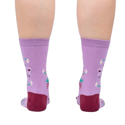 A pair of purple socks with a wine glass and grapes pattern. The socks have a red toe and heel.