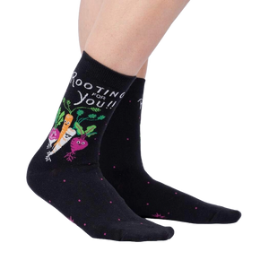 A pair of black socks with a pattern of radishes on them.