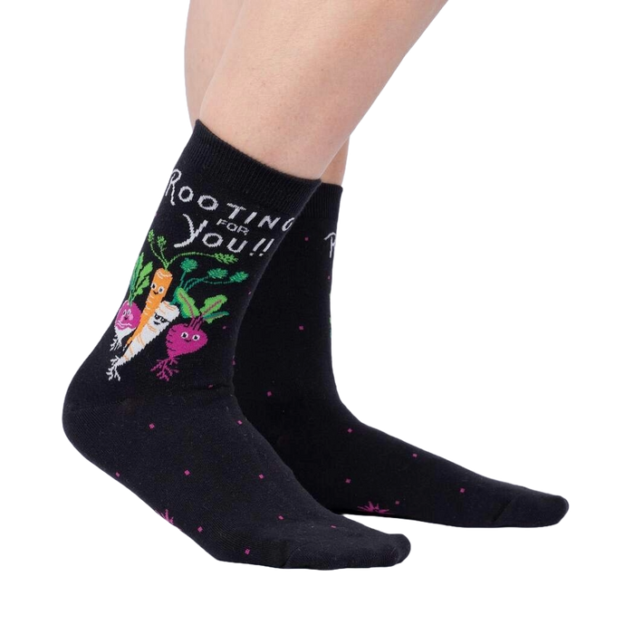 A pair of black socks with a pattern of radishes on them.