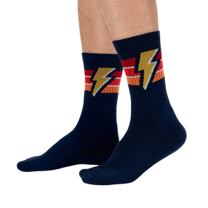 Lifestyle shot of male model wearing navy blue Thunderstruck socks.