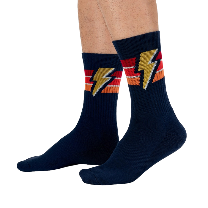Lifestyle shot of male model wearing navy blue Thunderstruck socks.