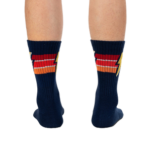 Rear view of navy blue Thunderstruck socks on a person's legs.