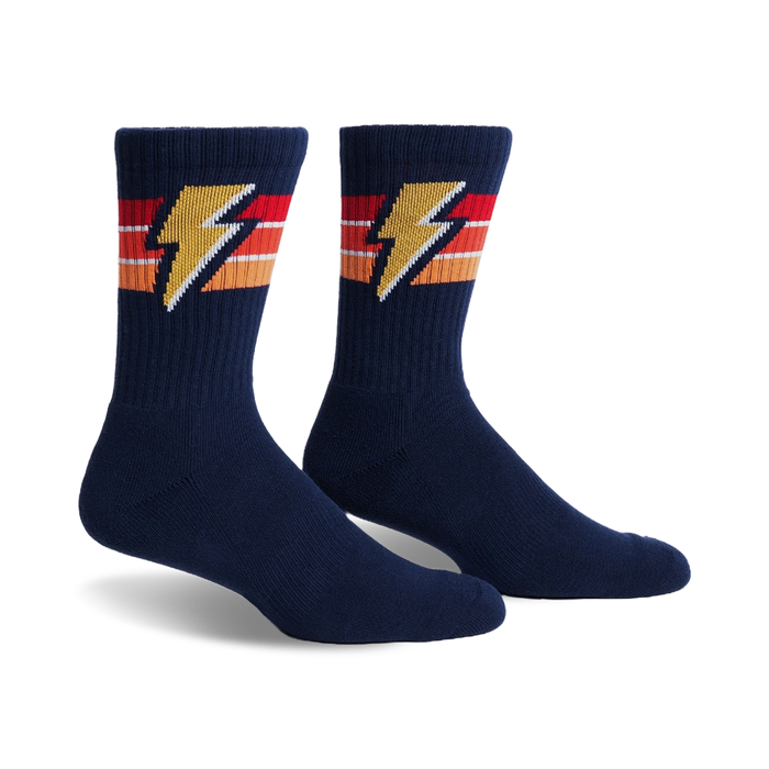 Pair of navy blue crew socks with retro orange, red, and yellow stripes and a lightning bolt design.