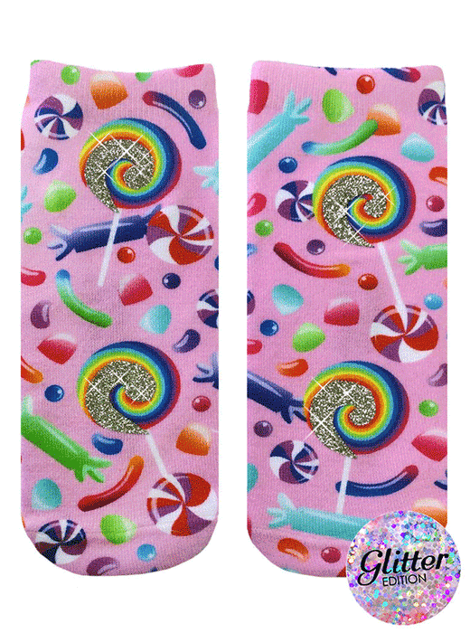 A pair of pink crew socks with a candy design.  Lollipops, gummy candies, and swirl candies are printed on a pink background with glitter accents. }}