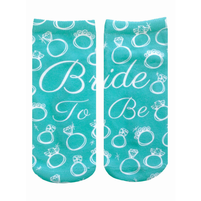 A pair of teal ankle socks with a pattern of white rings and diamonds. Text reads, 'Bride To Be'. Perfect for brides-to-be! }}