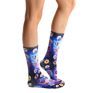 A pair of legs is shown from the knees down. The person is wearing a pair of socks with a repeating pattern of space, donuts, and dogs in sunglasses.