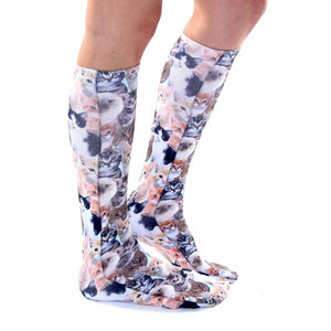 Lifestyle shot of a person wearing Kitty All Over knee-high socks, showcasing the fit and pattern.