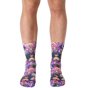 A pair of crew socks with a galaxy print featuring various breeds of dogs in a purple, pink, and black color scheme.
