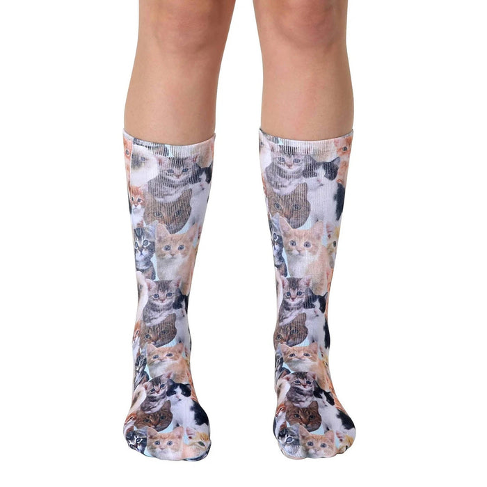 Crew socks featuring an all-over print of adorable kittens in various colors and poses on a light background.