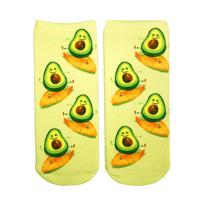 Pair of ankle socks on white background. Light green background with cartoon avocados riding orange tortilla chips. }}