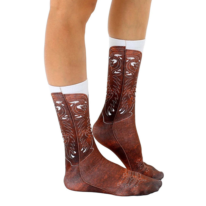 Lifestyle photo: Person wearing brown cowboy boot socks with jeans.