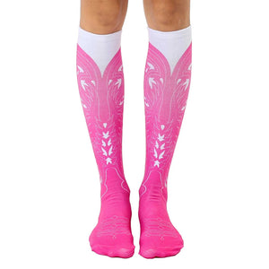 Pair of pink and white knee-high socks with a cowgirl boot design.  The socks are predominantly hot pink with a white boot graphic.