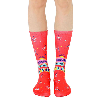 Pair of red crew socks featuring a playful 'unsubscribe from your issues' graphic with 90s-inspired design elements.