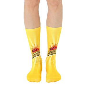 A pair of yellow crew socks with a graphic of a sun and the phrase 'Ray of Fucking Sunshine'.