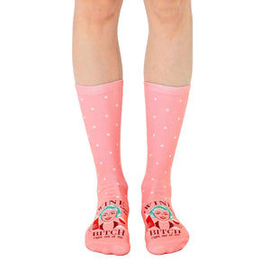Women's crew socks in pink with white polka dots and a retro illustration of a woman with wine, saying 'Wine Bitch'.