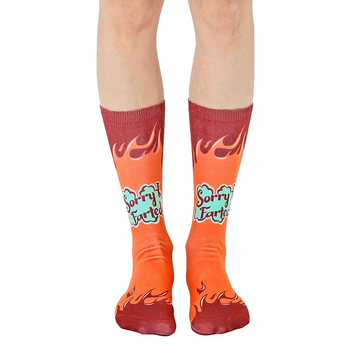 A pair of orange crew socks with maroon flames and 'Sorry I Farted' text in teal. Fun and comfortable!