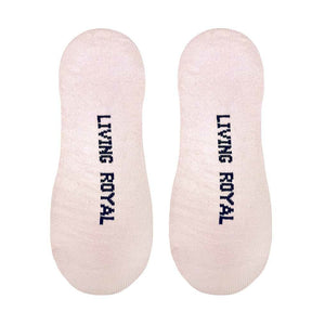 A pair of light pink no-show socks with the words 