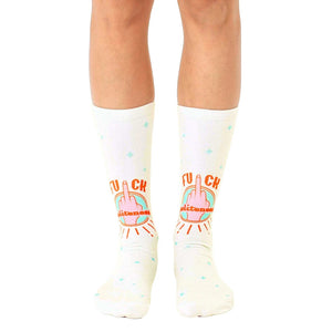 Cream-colored crew socks featuring a repeated design of a middle finger with 'F*ck Politeness' in orange and teal.