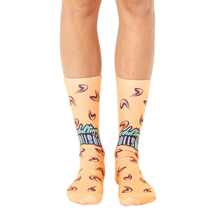 A pair of peach-colored crew socks with a teal 'Adulting is BS' graphic and small fortune cookie designs. Fun and comfy!