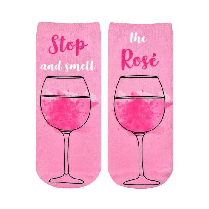 Pair of pink ankle socks featuring a rosé wine glass graphic and the text 'Stop and smell the Rosé'. }}