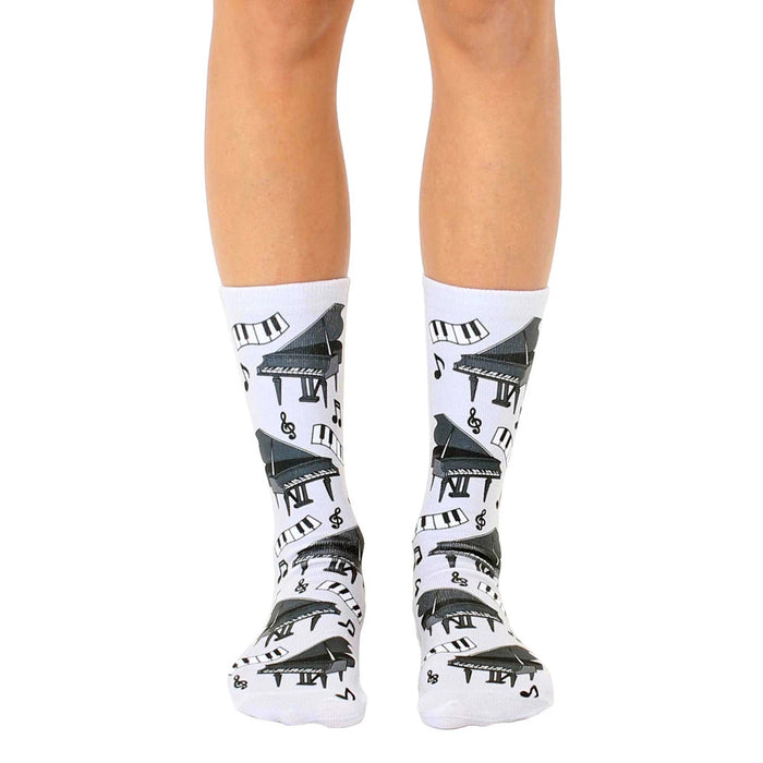 A pair of white crew socks with a fun print of black grand pianos and musical notes.  Perfect for music lovers!