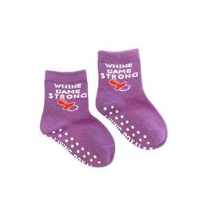 A pair of purple baby socks with white and red text that says 