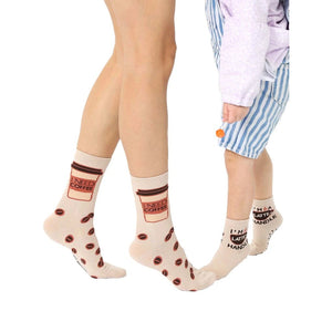Beige crew socks with coffee cup and bean designs. Adult socks say
