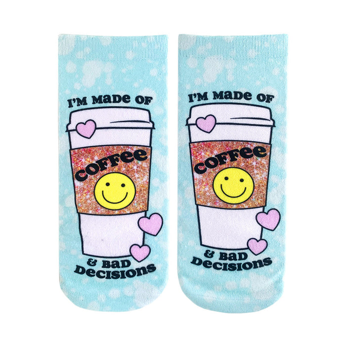 A pair of light blue tie-dye ankle socks feature a coffee cup design with a smiley face and the text 'I'm made of Coffee & Bad Decisions'. }}