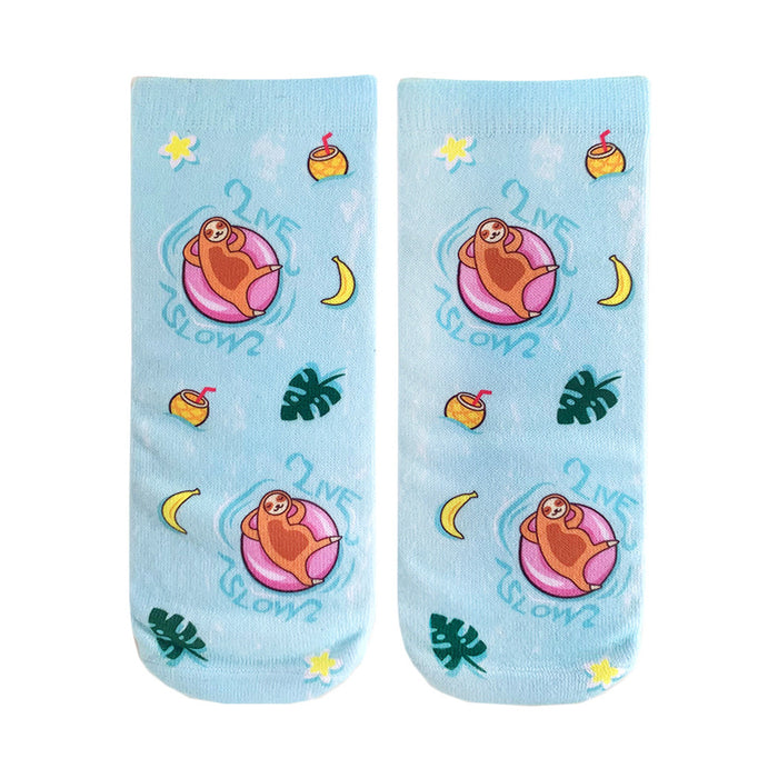Pair of light blue crew socks.  Design features sloths on pink floaties, tropical fruits, plants, and the text 'Live Slow'. }}