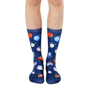 Crew socks showcasing a navy blue background with colorful planets, stars, and planet names. Fun, space-themed socks.