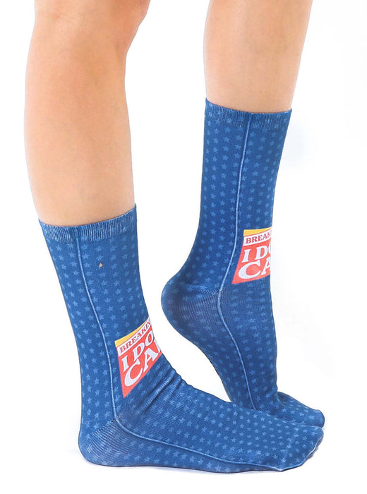 A pair of blue socks with a pattern of white stars. The socks have the words 