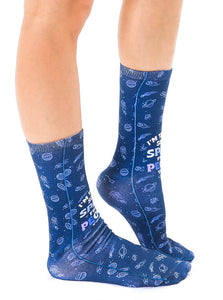 A pair of blue socks with a repeating pattern of planets, stars, comets, and the words 