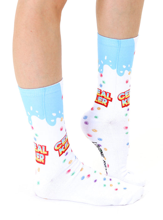Lifestyle shot of a person's legs wearing the Cereal Killer socks.  Shows the socks on a foot and lower leg.