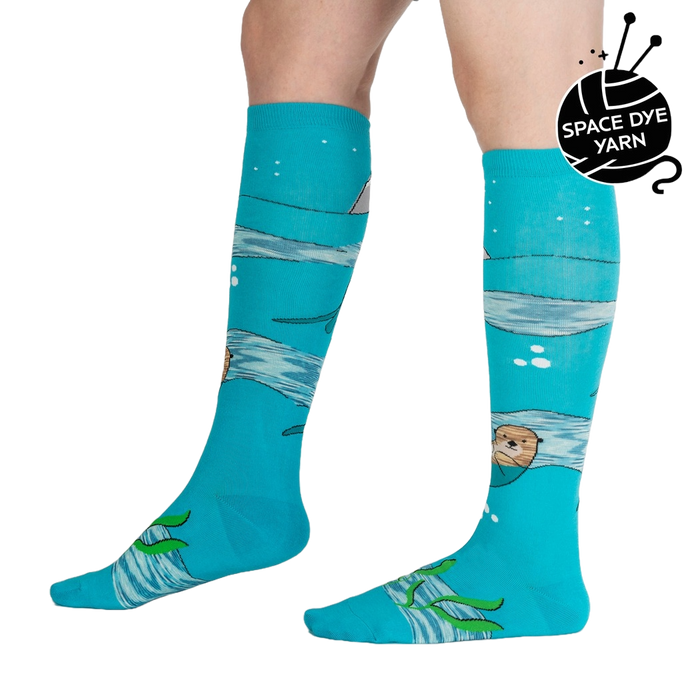 Lifestyle shot of model wearing 'Plays Well With Otters' knee-high socks, showcasing the fun, whimsical design.