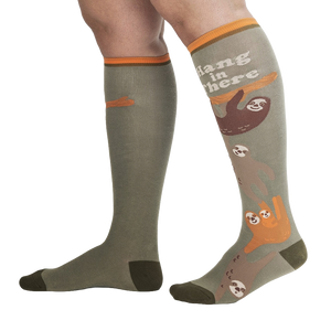 Lifestyle shot of a person wearing the 'Hang in There' sloth socks.