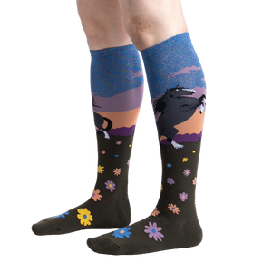 Lifestyle shot: Model wearing a pair of 'Black Beauty' knee-high socks, showing the design and fit.