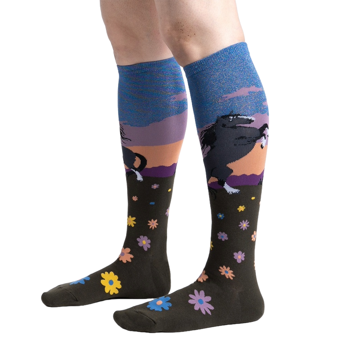 Lifestyle shot: Model wearing a pair of 'Black Beauty' knee-high socks, showing the design and fit.